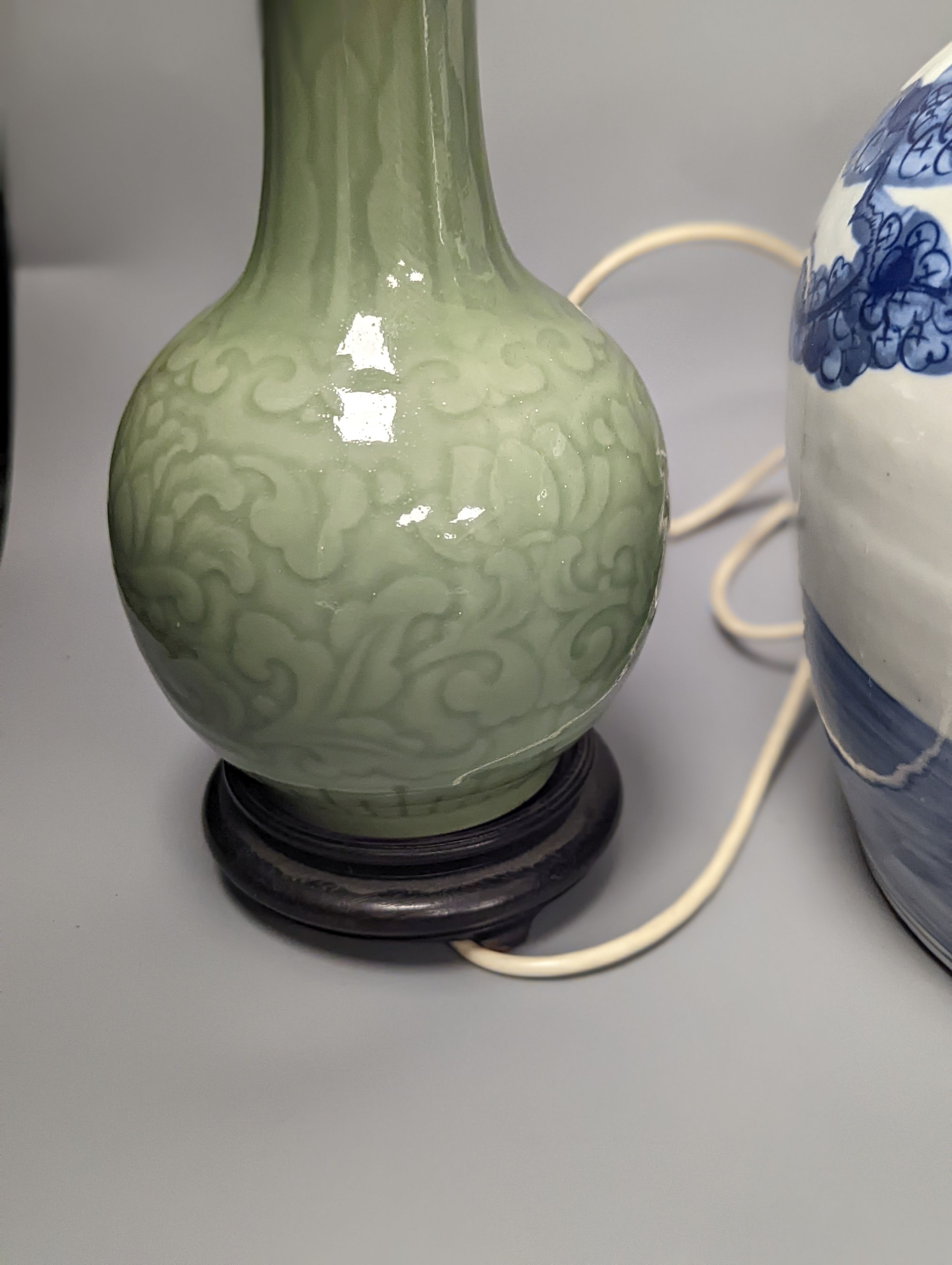 A Chinese blue and white jar and cover, 25 cm high and a celadon glazed lamp